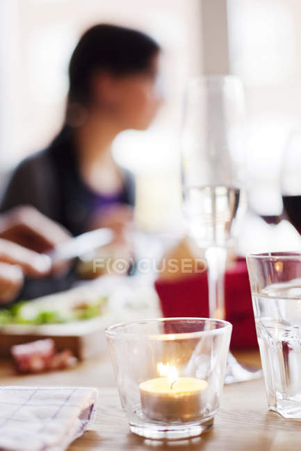 Candle on restaurant table — Stock Photo