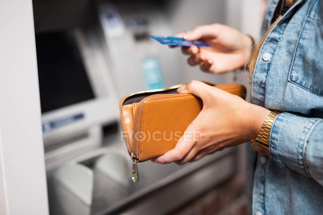 Woman withdrawing money — Stock Photo