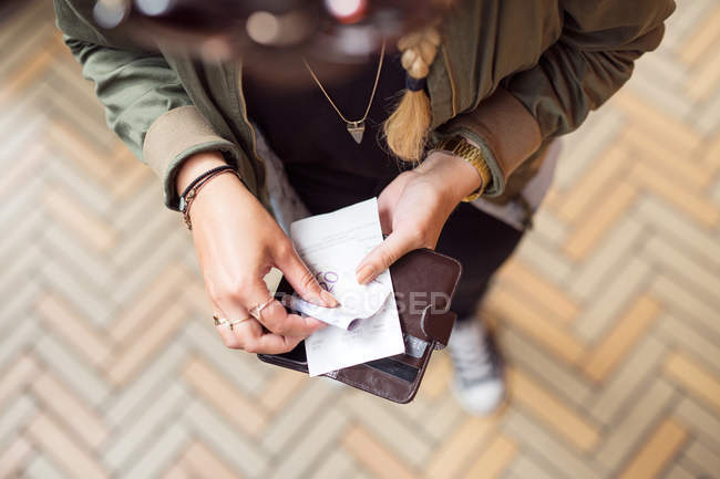 Woman holding open wallet — Stock Photo