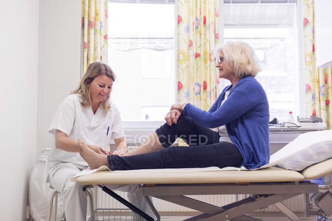 Senior woman with doctor — Stock Photo