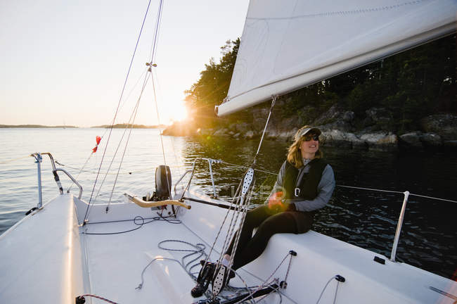 Жінка сидить на вітрильному човні — стокове фото