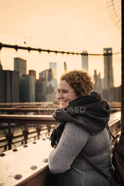 Mujer sonriente y rascacielos - foto de stock