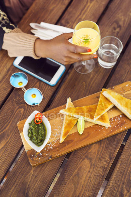 Appetizer and juice in front of woman — Stock Photo
