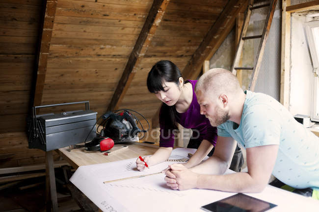 Couple working on renovating blueprint — Stock Photo