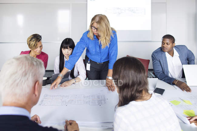 Team of architects working with blueprints — Stock Photo