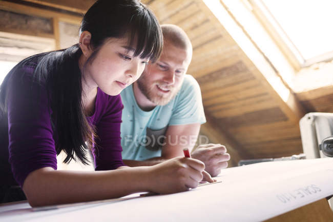 Couple working on renovating blueprint — Stock Photo