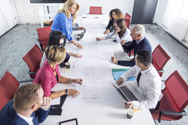 Team of architects working with blueprints — Stock Photo