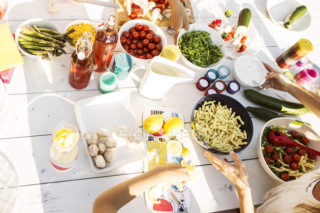 High angle view of people preparing food for garden party — Stock Photo