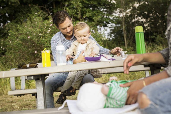 Father sitting with son at picnic table — Stock Photo
