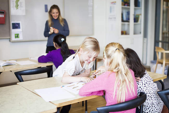 Four girls learning in classroom — Stock Photo