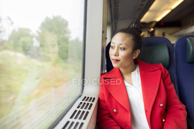 Woman in red coat — Stock Photo