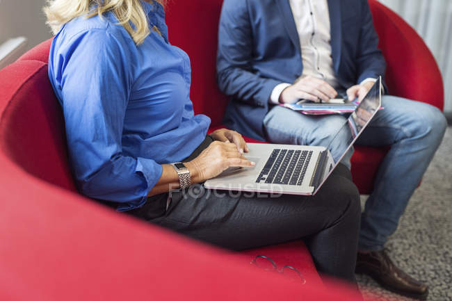Colleagues sitting with laptop — Stock Photo