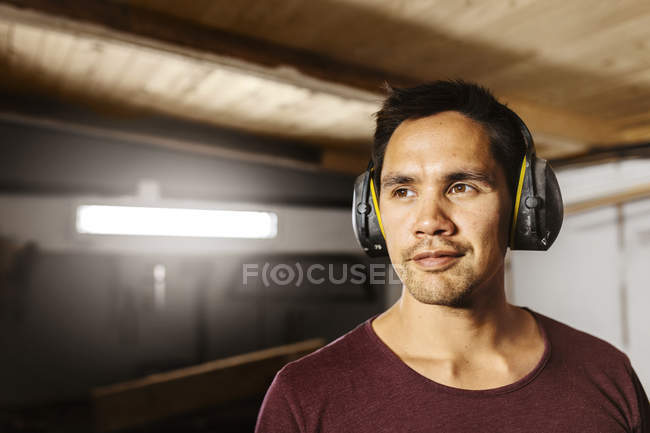 Portrait of man wearing ear muffs — Stock Photo