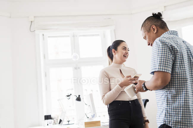 Coworkers laughing in office indoors — Stock Photo