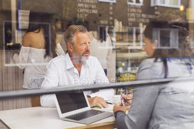 Senior man and mature woman talking in cafe — Stock Photo