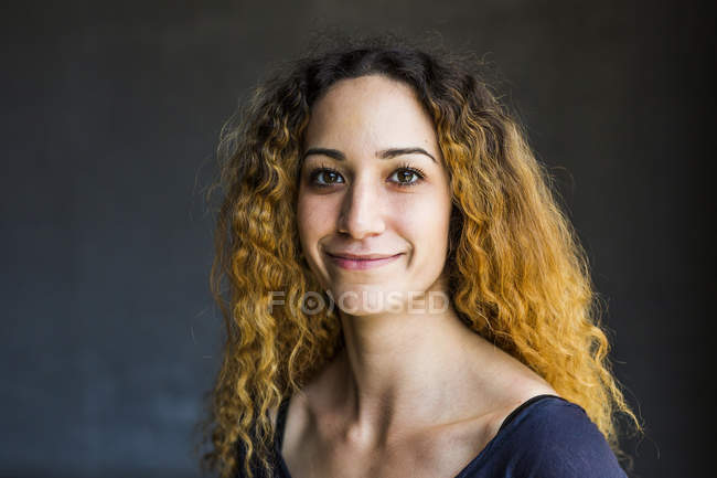 Portrait of young woman on dark background — Stock Photo