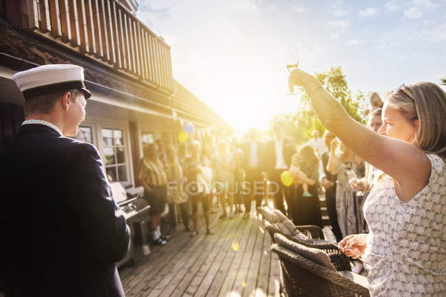 Mother and son raising toast at graduation party — Stock Photo
