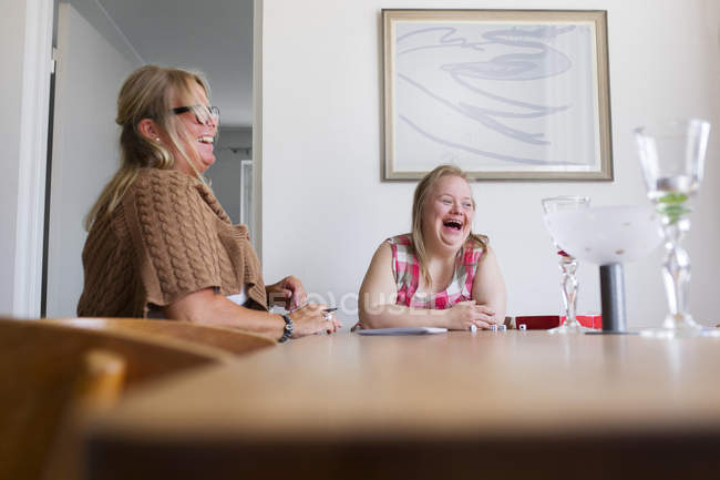 Mother and daughter with down syndrome playing game — Stock Photo