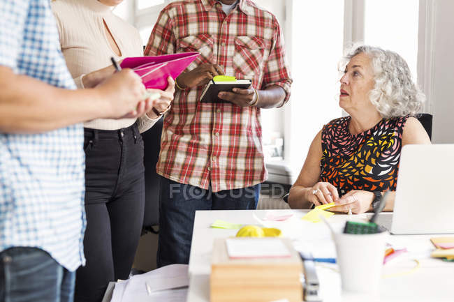 Coworkers writing during business meeting — Stock Photo