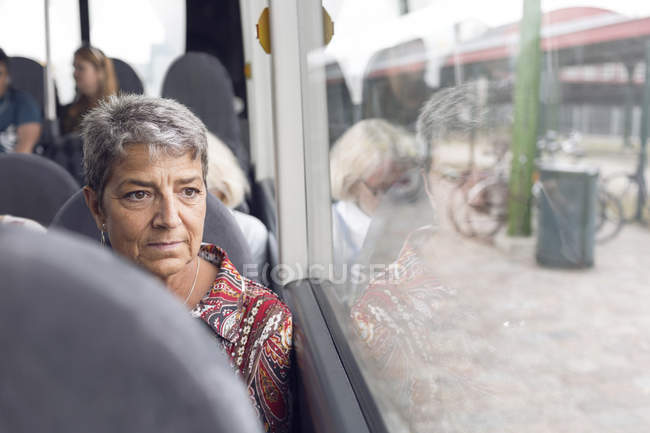 Mulher olhando através da janela de ônibus — Fotografia de Stock