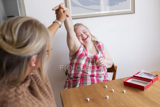 Mère et fille avec le syndrome du duvet jouer au jeu — Photo de stock