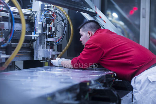 Worker in uniform adjusting equipment — Stock Photo
