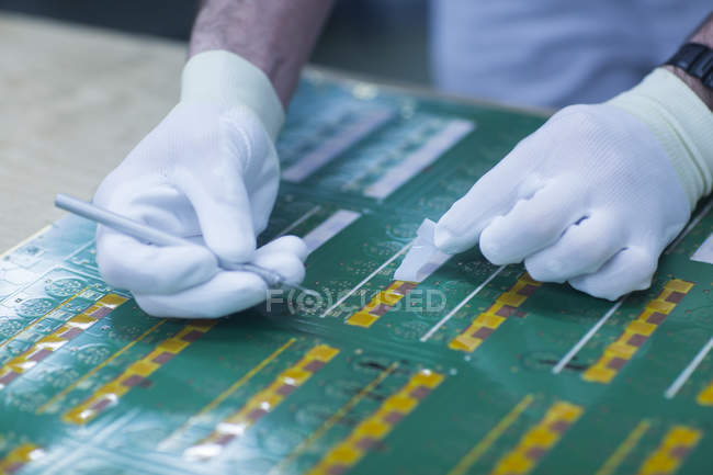 Worker in gloves working on conductor board — Stock Photo