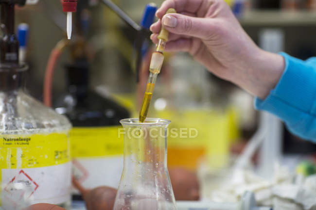 Woman working with substances in laboratory — Stock Photo