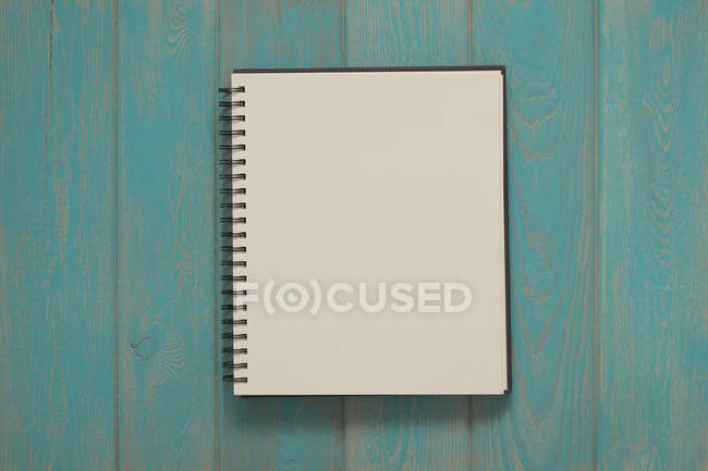 Note book on blue wooden desk. — Stock Photo