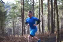 Uomo che corre nel bosco — Foto stock