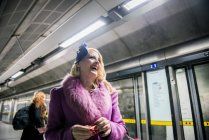 Woman standing on a tube platform — Stock Photo