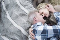 Senior couple cuddling together on blanket — Stock Photo