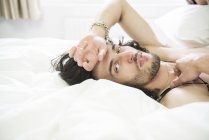 Man lying in bed — Stock Photo