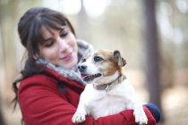 Woman holds jack russell terrier — Stock Photo