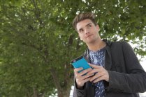 Man standing with phone in hands — Stock Photo