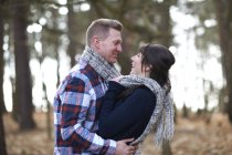 Couple embracing in forest — Stock Photo