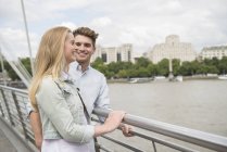 Couple standing on Millennium Bridge — Stock Photo