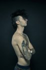 Tattooed man with unusual hairstyle — Stock Photo