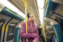 Woman travelling on tube train — Stock Photo