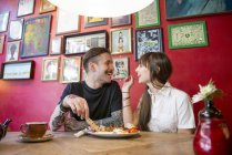 Couple enjoying meal in coffee shop — Stock Photo