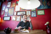 Homme manger à dans un café — Photo de stock