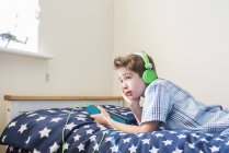 Boy listening music in headphones — Stock Photo