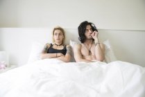 Couple lying in double bed after dispute — Stock Photo