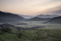 Countryside fields towards misty Snowdonia mountain — Stock Photo