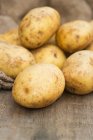 Mucchio di patate su tavolo di legno — Foto stock