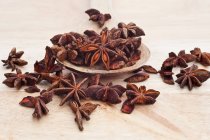 Star anise on wooden serving spoon — Stock Photo
