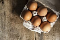 Fresh eggs in egg box — Stock Photo