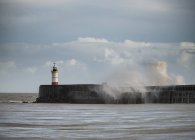 Huge sea waves crashing over lighthouse — Stock Photo
