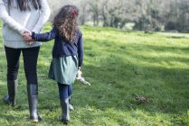 Mother and daughter walking in garden — Stock Photo