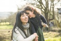 Mother and daughter in spring garden — Stock Photo